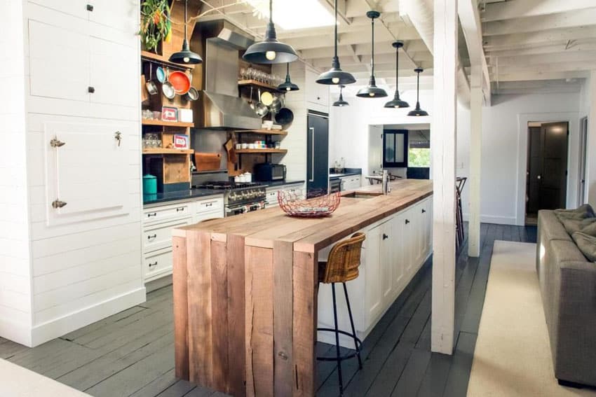 Kitchen with wood plank island, undercounter cabinets and open shelving