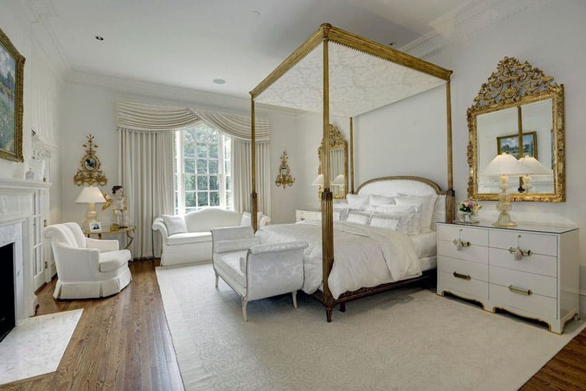 White theme french style bedroom with four poster bed in gold with white bed seat and furniture