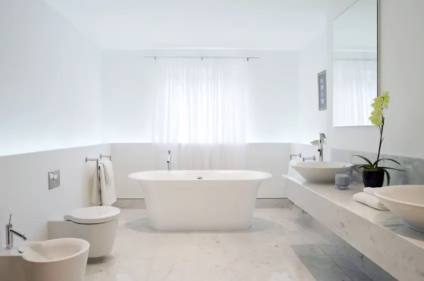 All white modern bathroom with freestanding bathtub