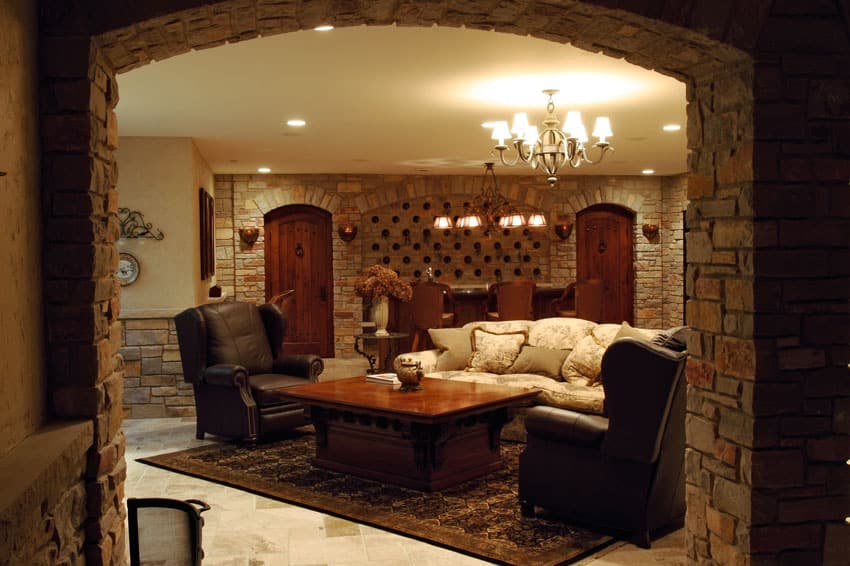 Basement lounge with custom stone walls and home bar