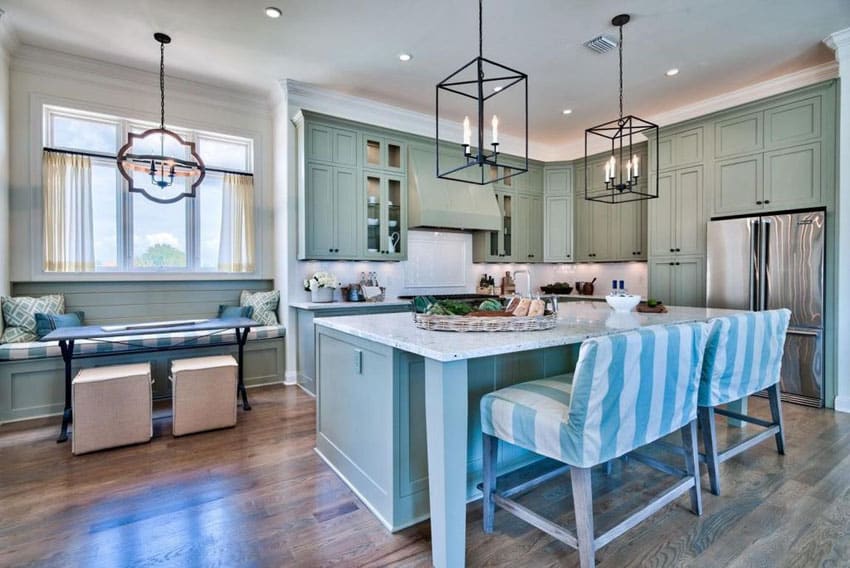 Beautiful cottage kitchen with aqua cabinets, breakfast bar island, white marble top counters and window seat bench