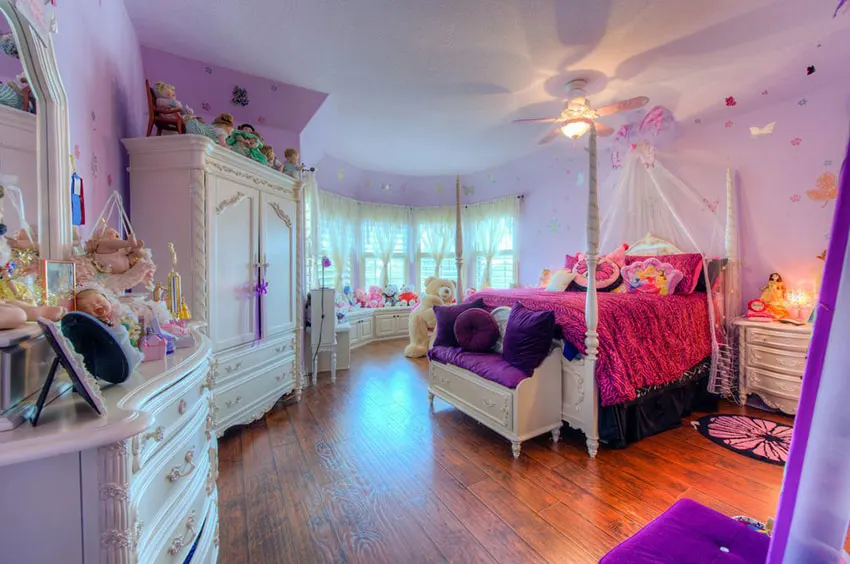Beautiful girls bedroom with white furniture and bright purple decor