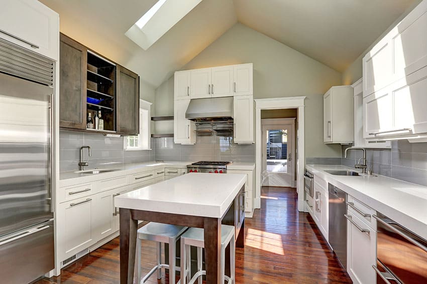 Beautiful u shaped kitchen with white cabinets white countertops and wood island