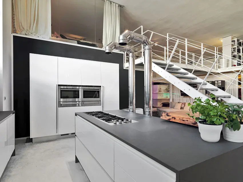 Black and white modern kitchen in loft apartment with high ceilings