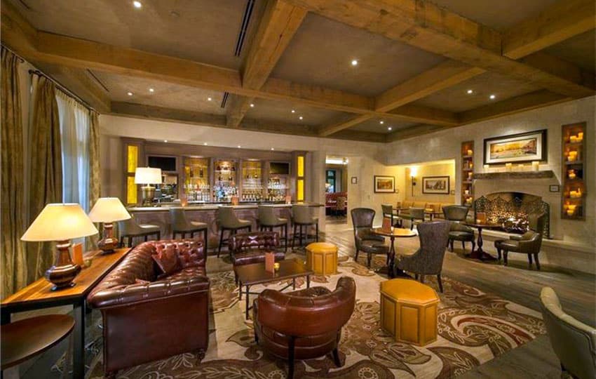 Cigar room man cave with home bar and leather furniture
