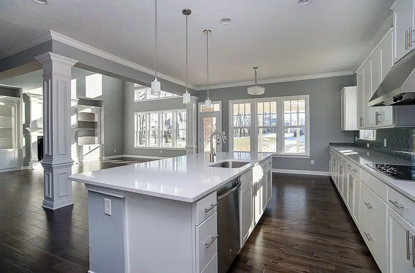 White kitchen cabinets with two tone white and gray island and gray wall paint