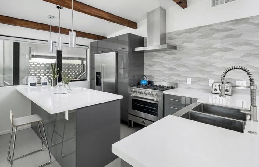 Contemporary kitchen with gray cabinets, white countertops, metallic backsplash and exposed wood beams