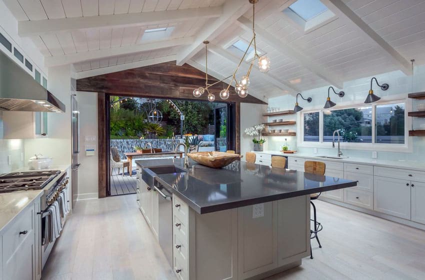 White kitchen with shiplap and skylights on ceiling