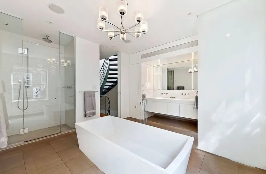 Contemporary master bathroom with silver chandelier and center tub