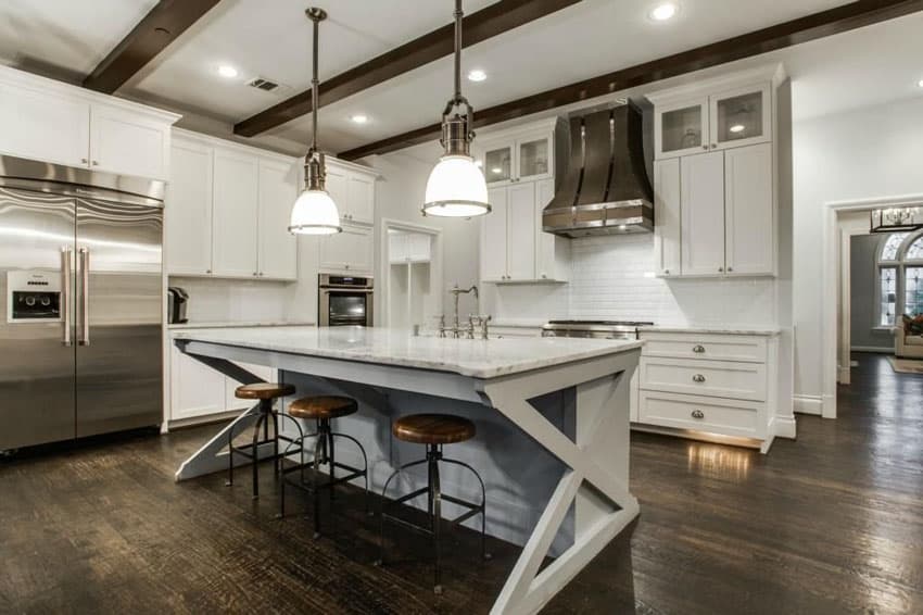 Cottage kitchen with white cabinets, breakfast bar island and carrara marble counters