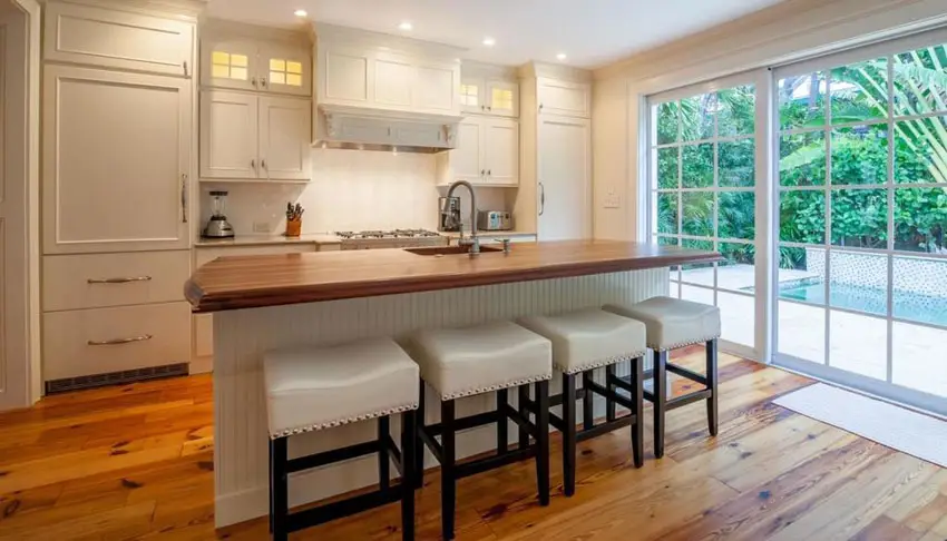 Kitchen with teak flooring, window panels and solid wood countertop