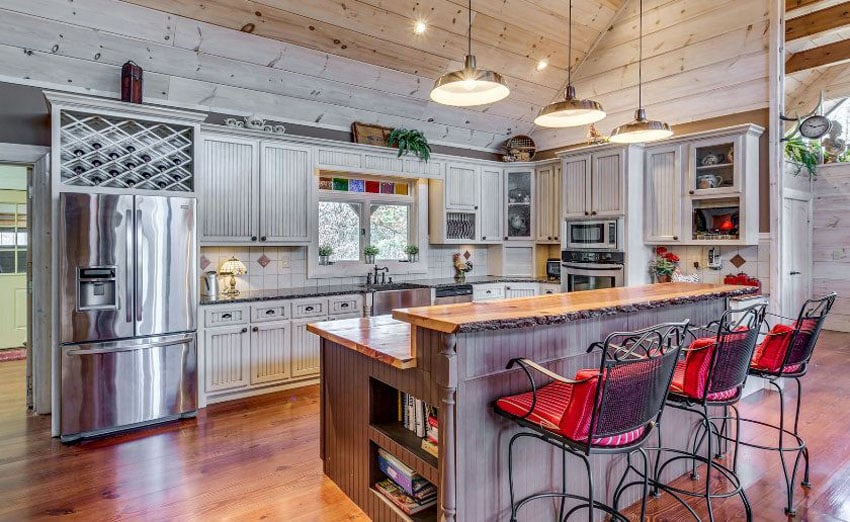 Country kitchen with beadboard cabinets and two level breakfast bar island