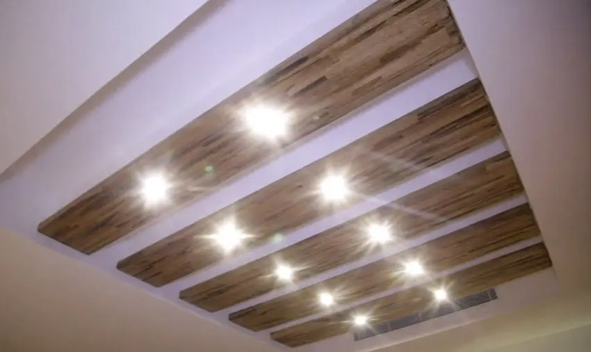 Custom recessed lighting with wood slats inside tray ceiling