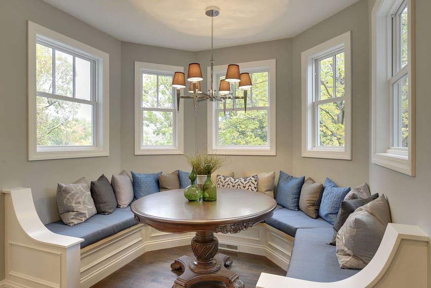 Bench with panel details, blue cushions and table top accessories