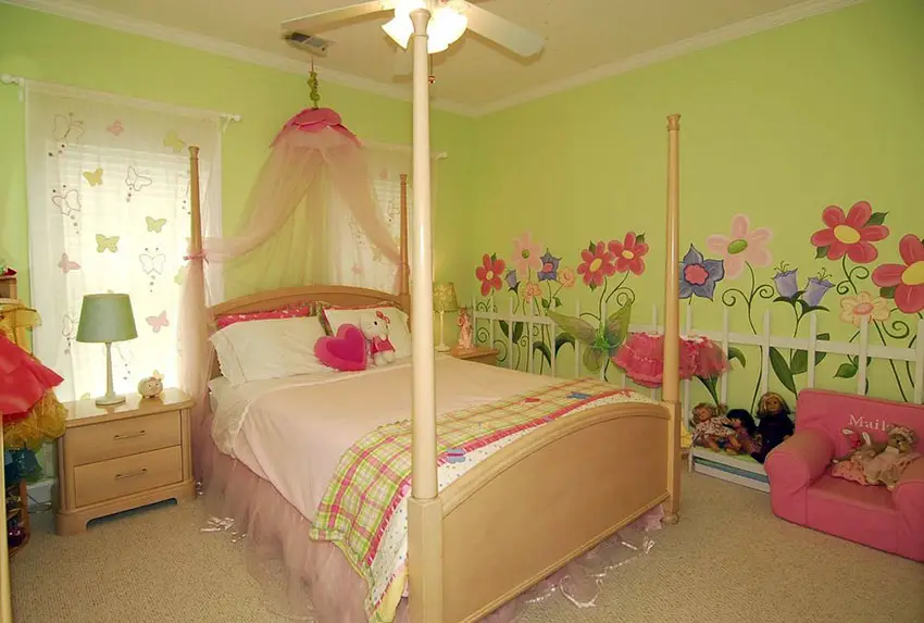 Room with wall decals of flowers and four poster bed