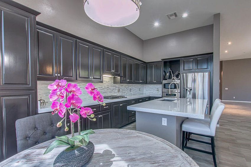 Dark tone kitchen cupboards and gray painted walls 