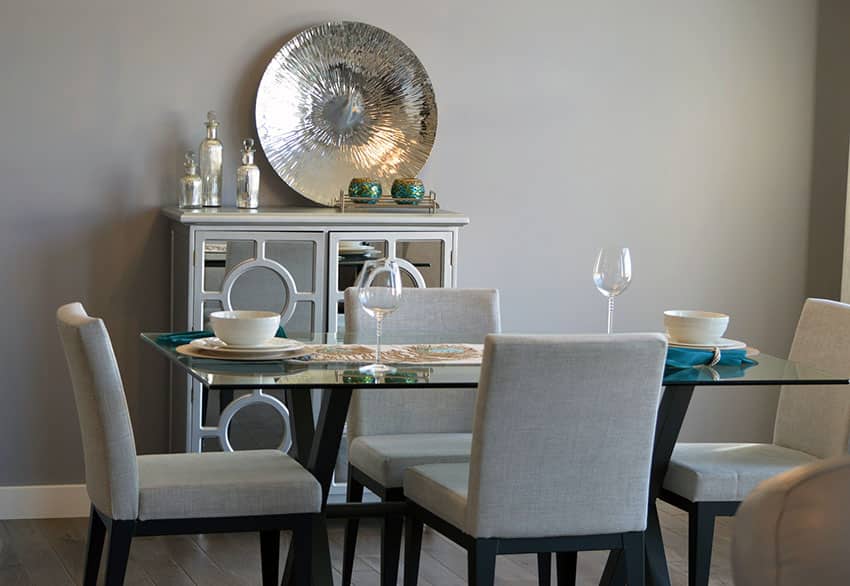 Dining room with gray contemporary chairs and glass table