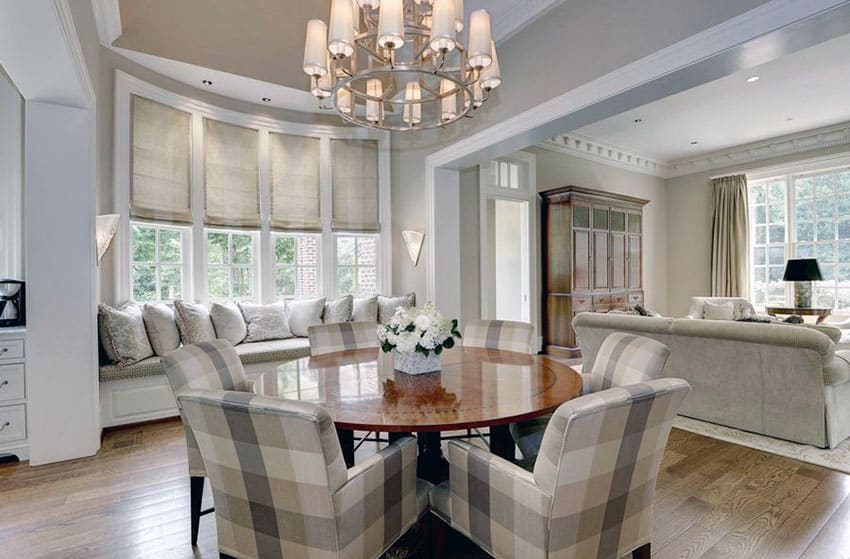 Open living space with checkered sofa dining chairs and chandeliers