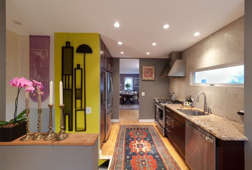 Eclectic galley kitchen with brown cabinets and yellow accent wall