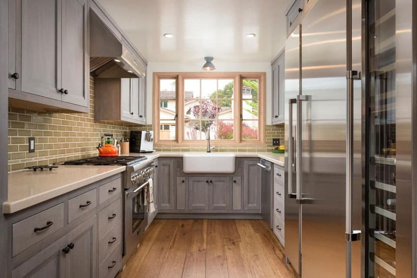 Galley kitchen with gray cabinets, quartz countertop and engineered oak floors