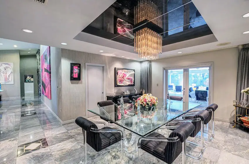 Modern dining room with high gloss black tray ceiling with linear chandelier