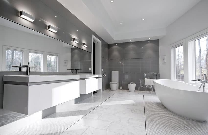 Gray and white palette bathroom with carrara marble flooring and resin tub