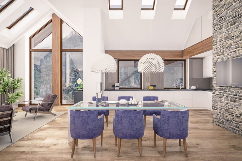 High ceiling dining room with purple chairs and light wood floors