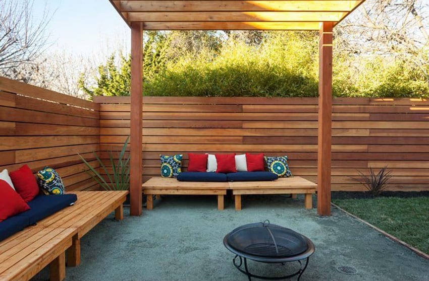 Horizontal wood fence with wood pergola, benches and portable fire pit