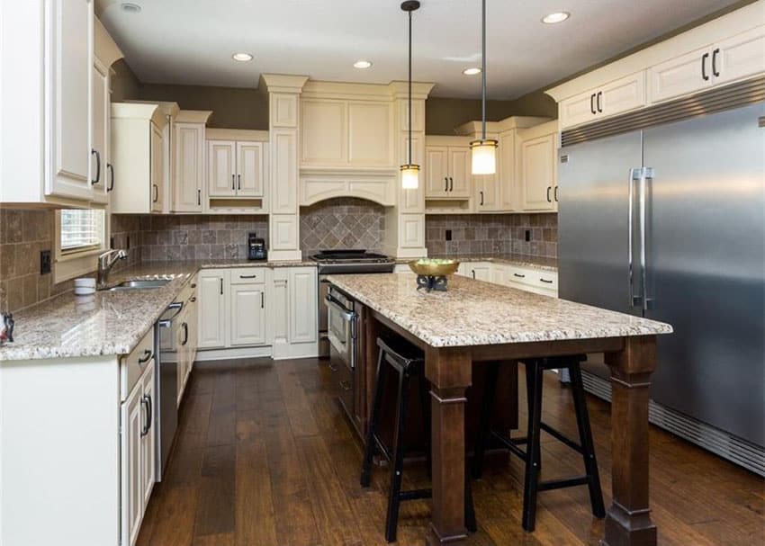 Kitchen with raised panel cabinets, stainless steel refrigerator and oak strip flooring