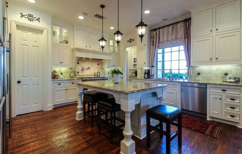 Kitchen with recessed panel antique white style cabinets, dark wood floors and white island