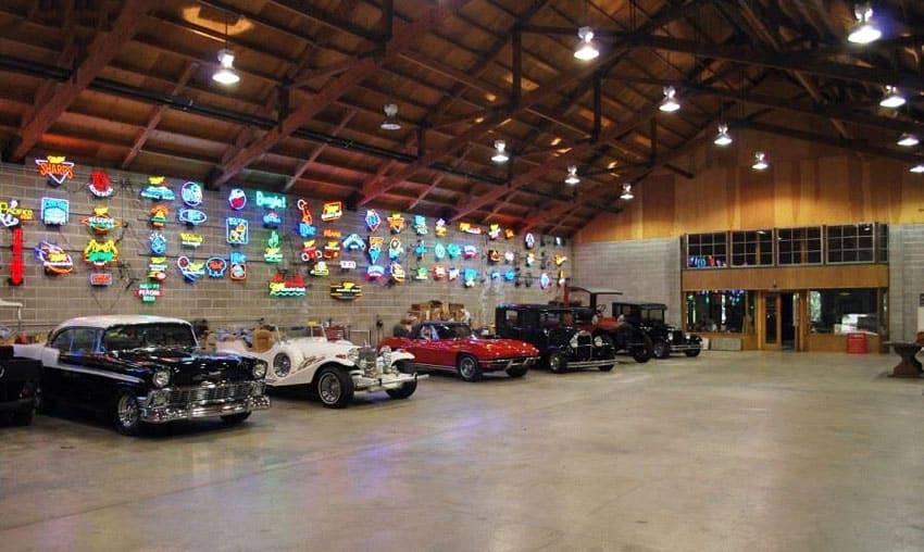 Luxury garage with collector cars and neon signs