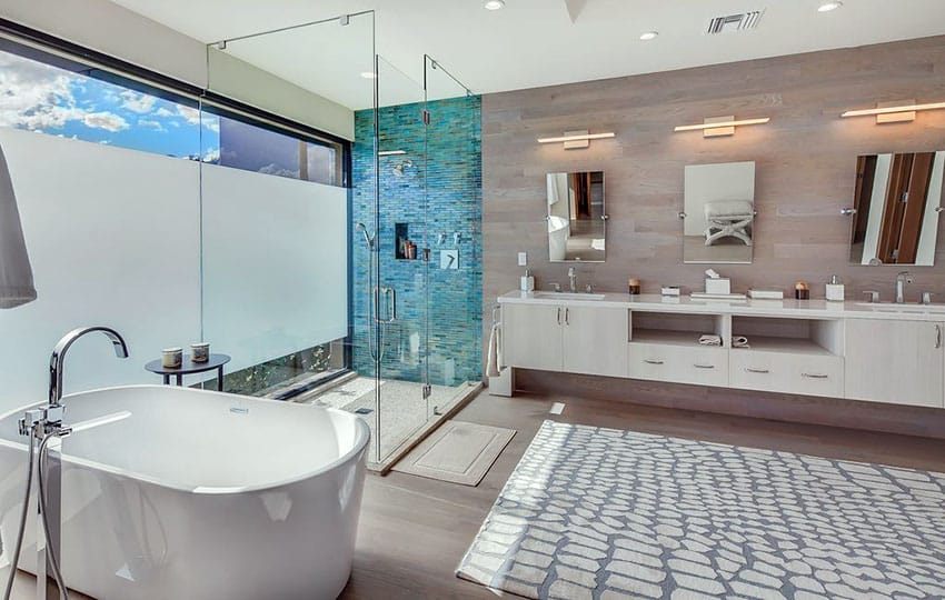 Modern bathroom with mirrors and sea green showe backsplash