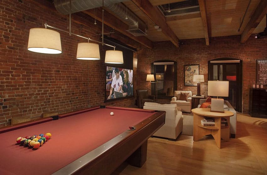 Man cave loft with pool table and brick walls