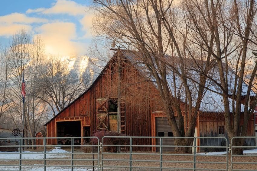 Metal farm fence with barn