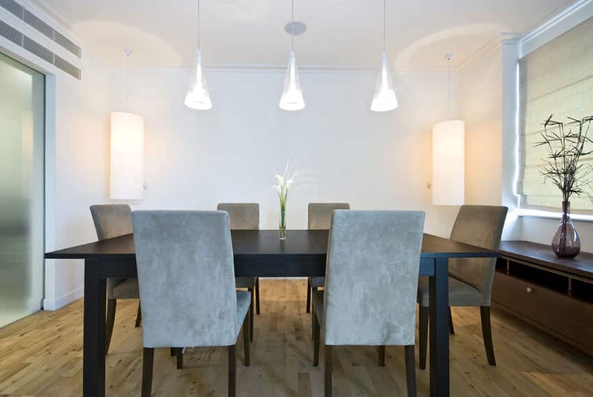 Minimalist room with cone lights and taupe velvet chairs