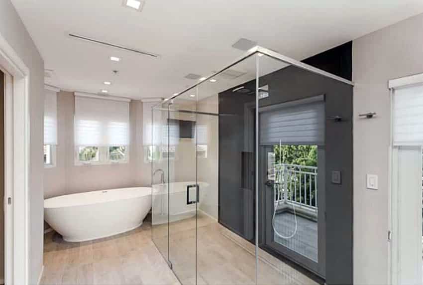 Modern bathroom with black accent wall and window in shower