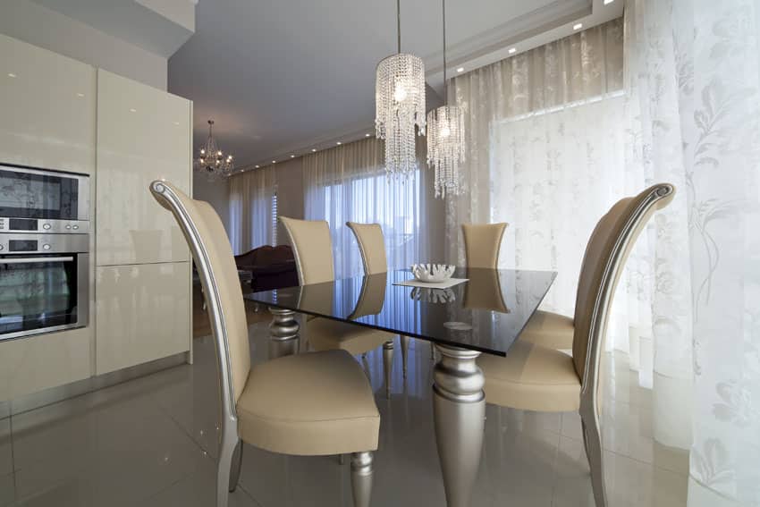 Modern beige dining room with glass chandelier pendant lights