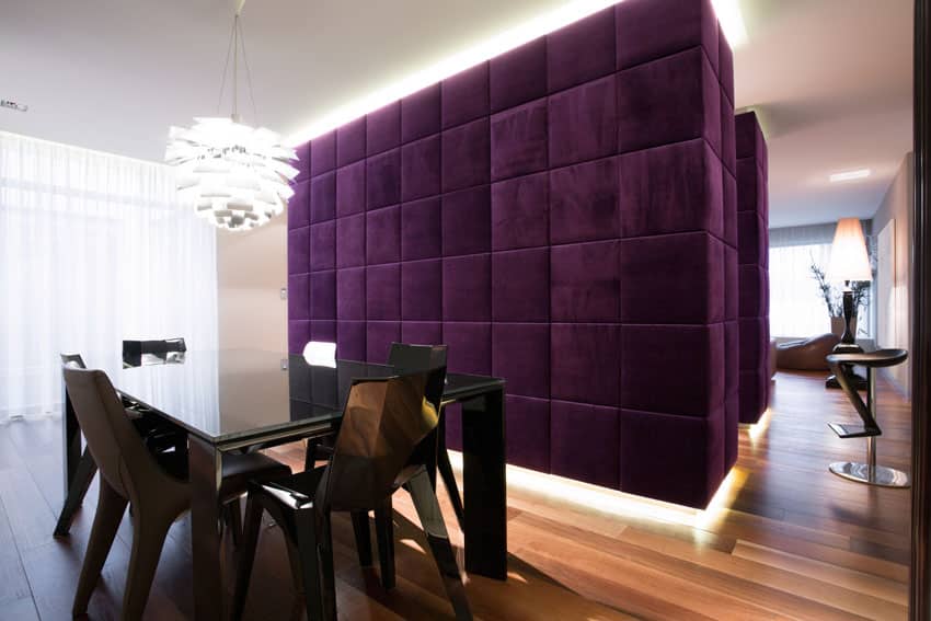 Plush purple accent wall with lace curtains