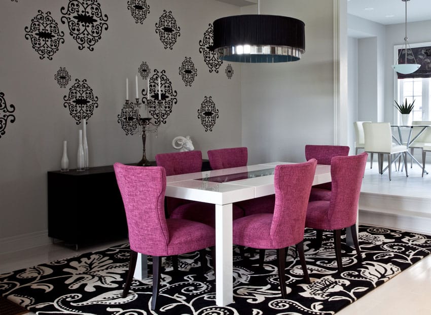 Modern dining room with purple chairs, drum pendant light and large patterned area rug