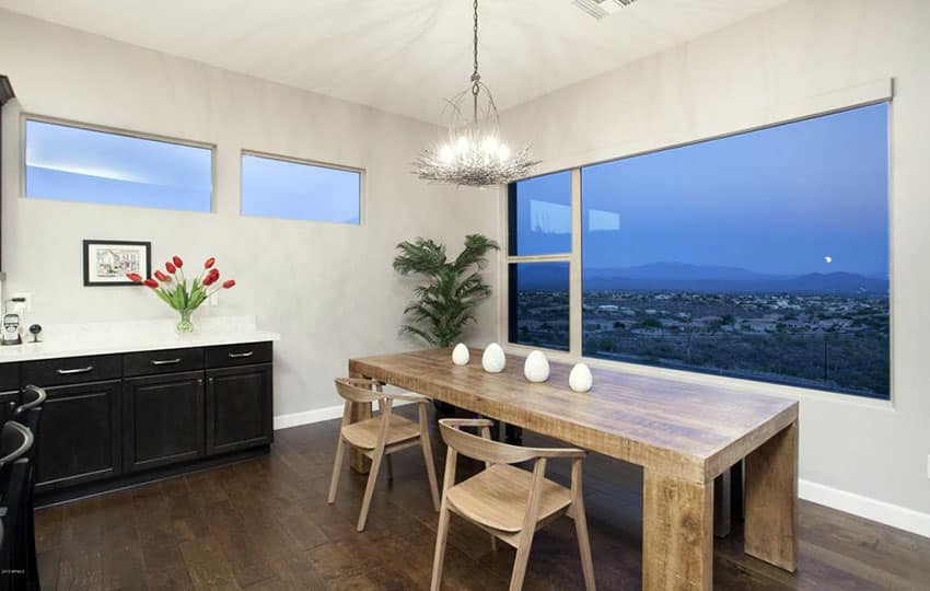 Solid table made of wood and a large picture window