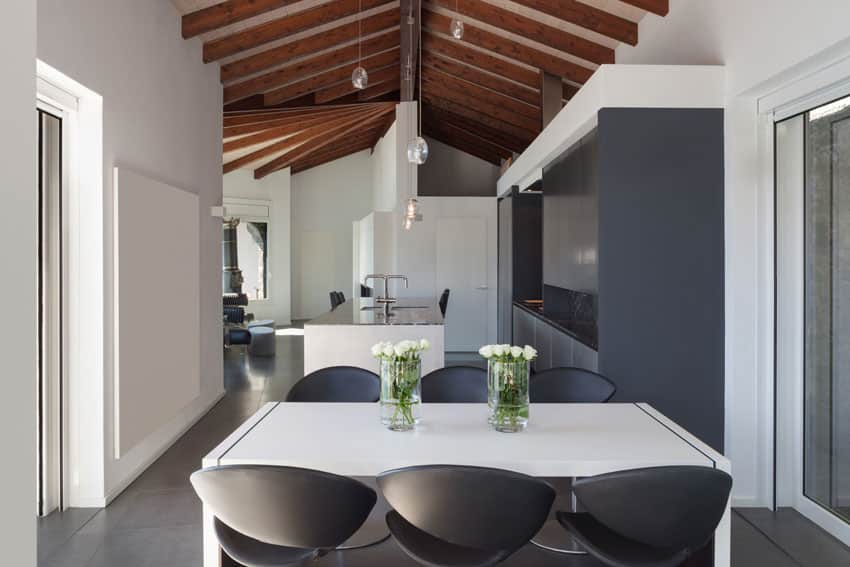 Room with vaulted ceiling with breakfast nook and cabinets in gunmetal finish