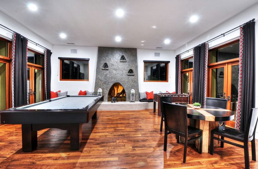 Modern game room with wood flooring and fireplace
