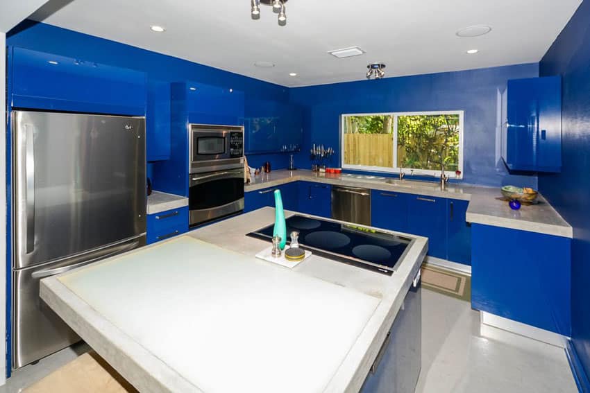 Modern kitchen painted blue walls and high gloss blue cabinets with white counters