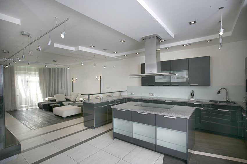 Open concept kitchen with suspended counter and grey cabinets