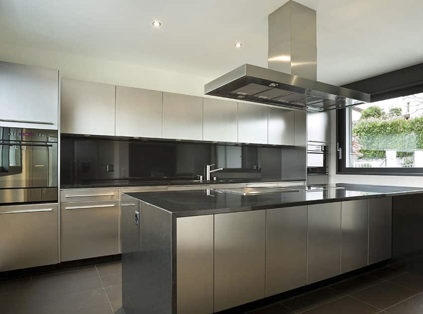 Modern kitchen with white cabinets, dark gray countertop and backsplash