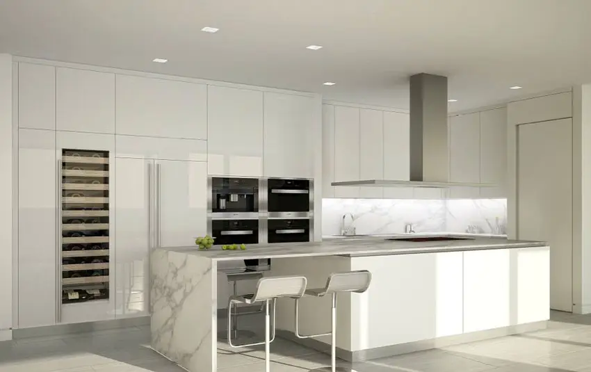 Modern kitchen with white cabinets, rectangular island with breakfast bar and wine fridge