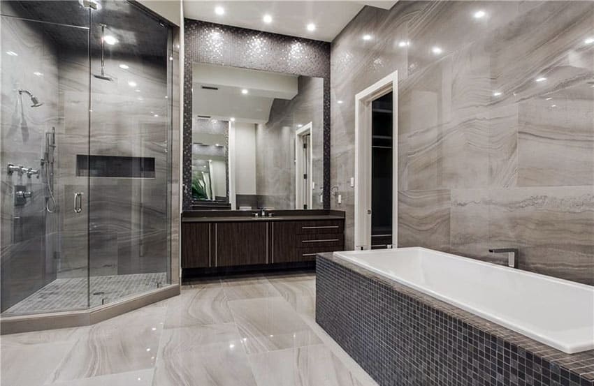 bathroom with gray limestone walls and rainfall shower