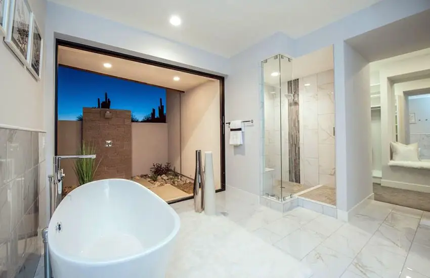Modern master bathroom with marble tile window view from bathtub