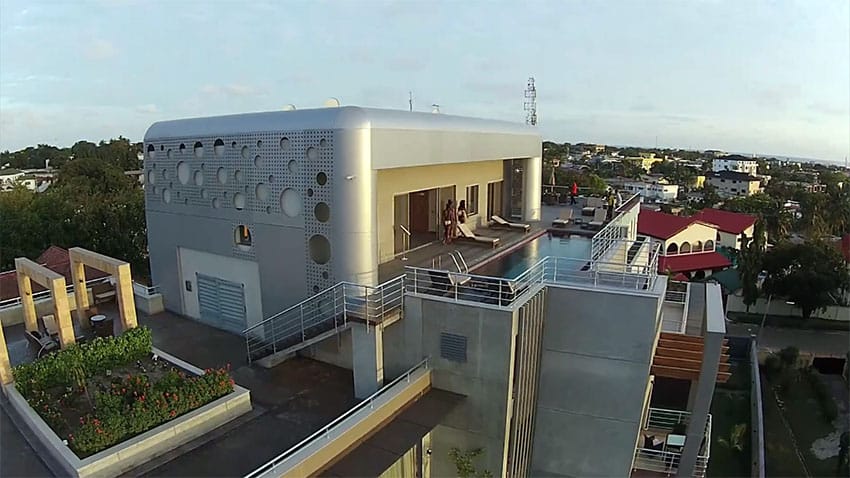 Rooftop pool with lounging chairs and railings