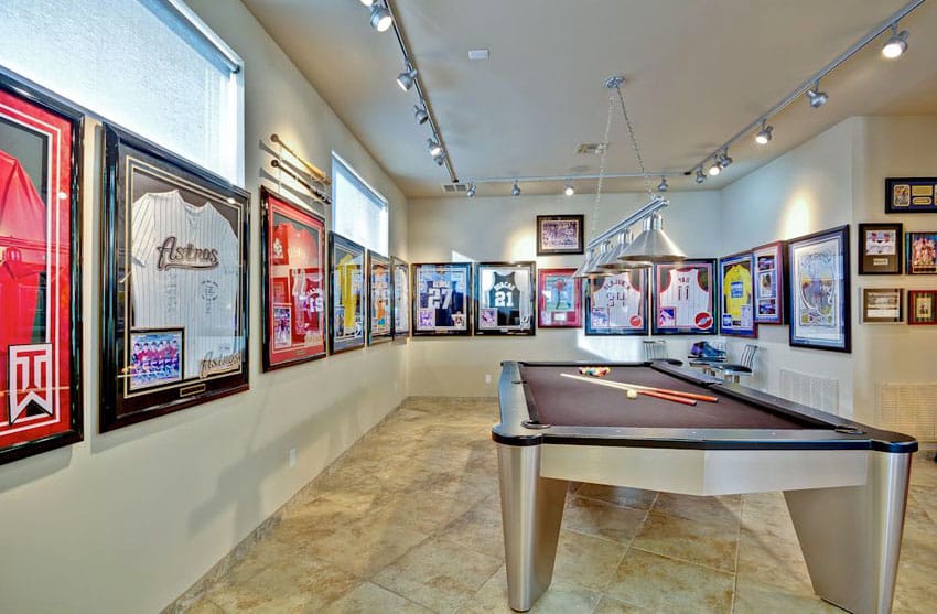 Pool table room with sports team jerseys